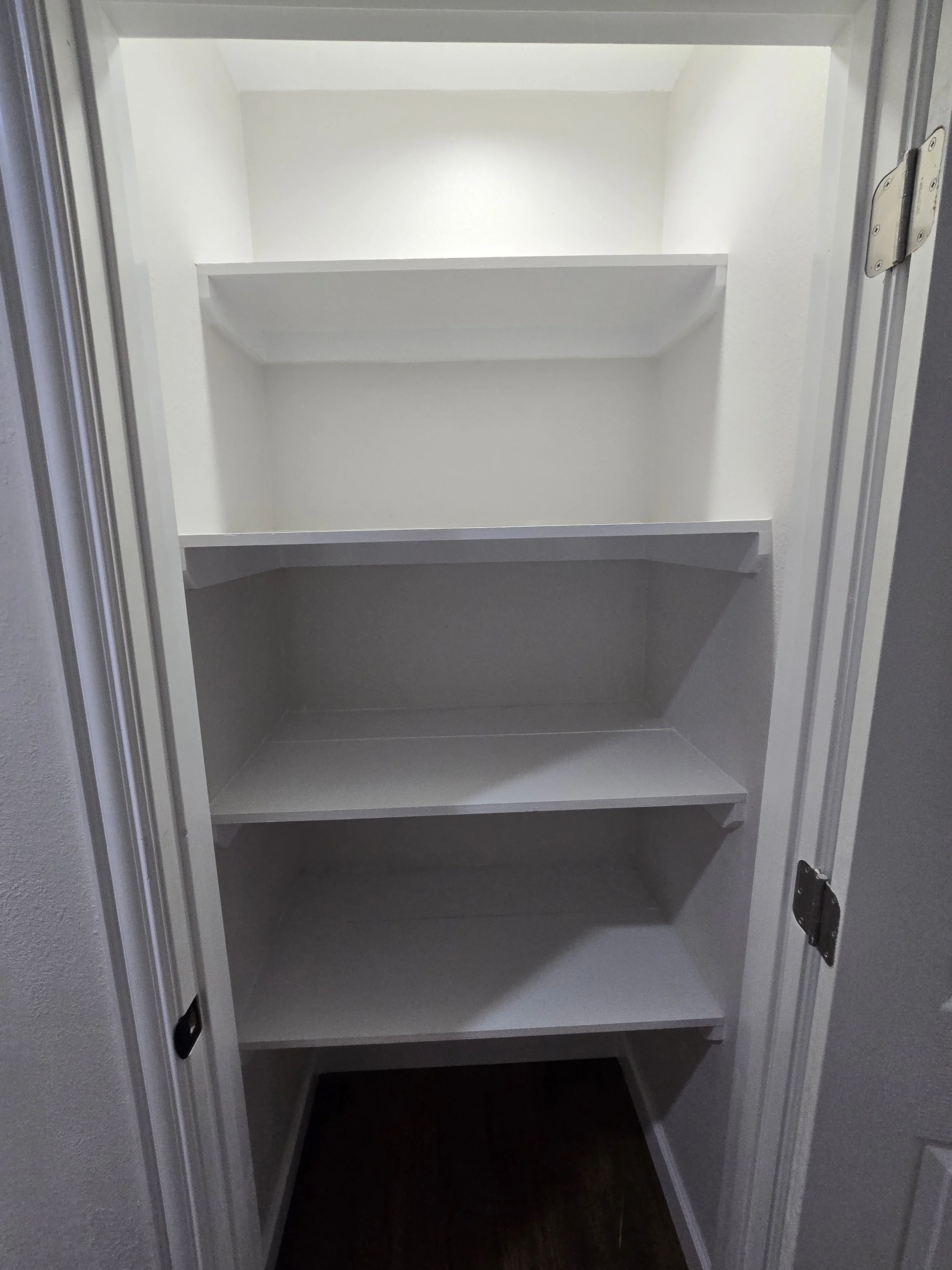 Freshly painted closet interior in West Houston, TX with smooth clean walls and a bright updated finish