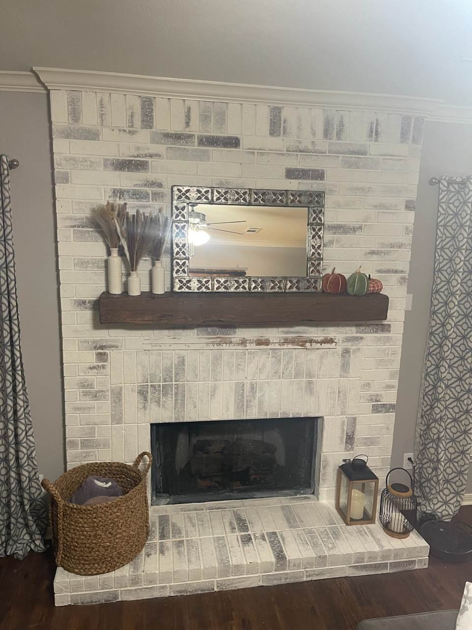 Interior repaint featuring a limewashed fireplace surround and textured feature wall, creating a focal point with clean edge definition.