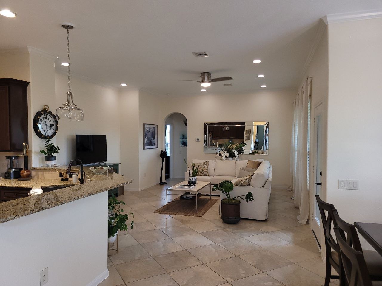 Freshly painted off-white living room and kitchen interior in Katy, Texas by professional house painters.
