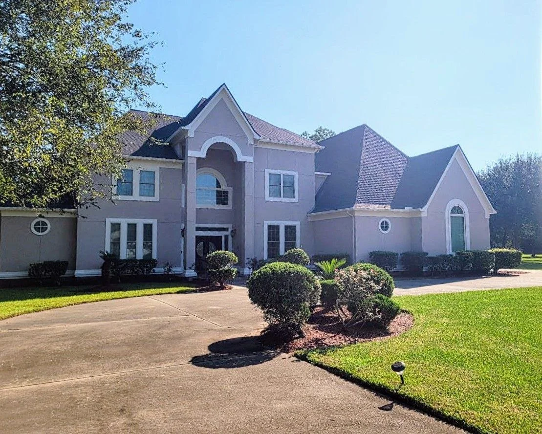 Very large stucco house exterior freshly painted in Missouri City, Texas by professional painters.