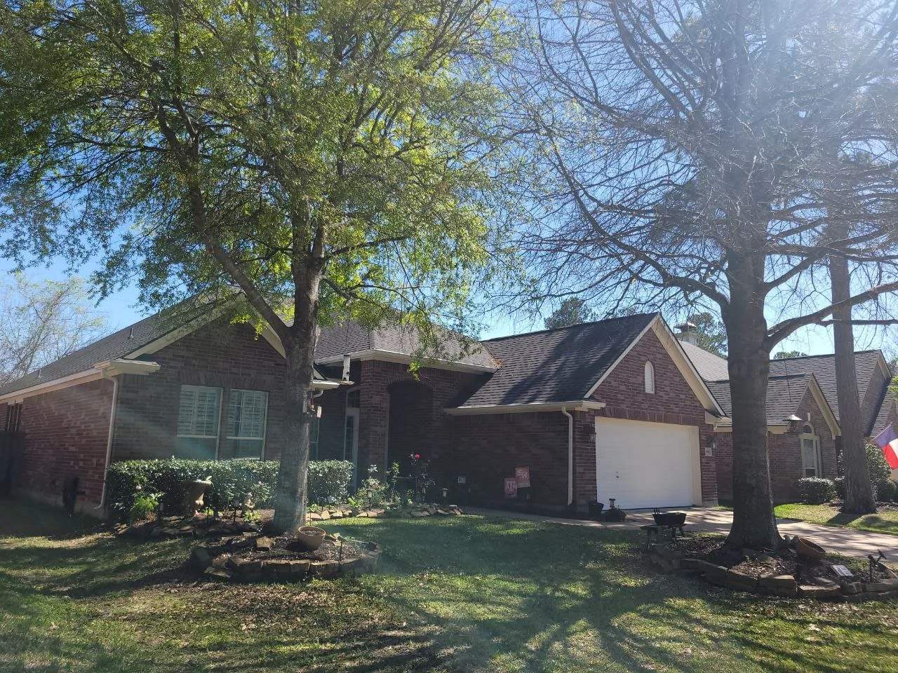 Freshly painted white exterior with red brick on a small house in Katy, Texas.