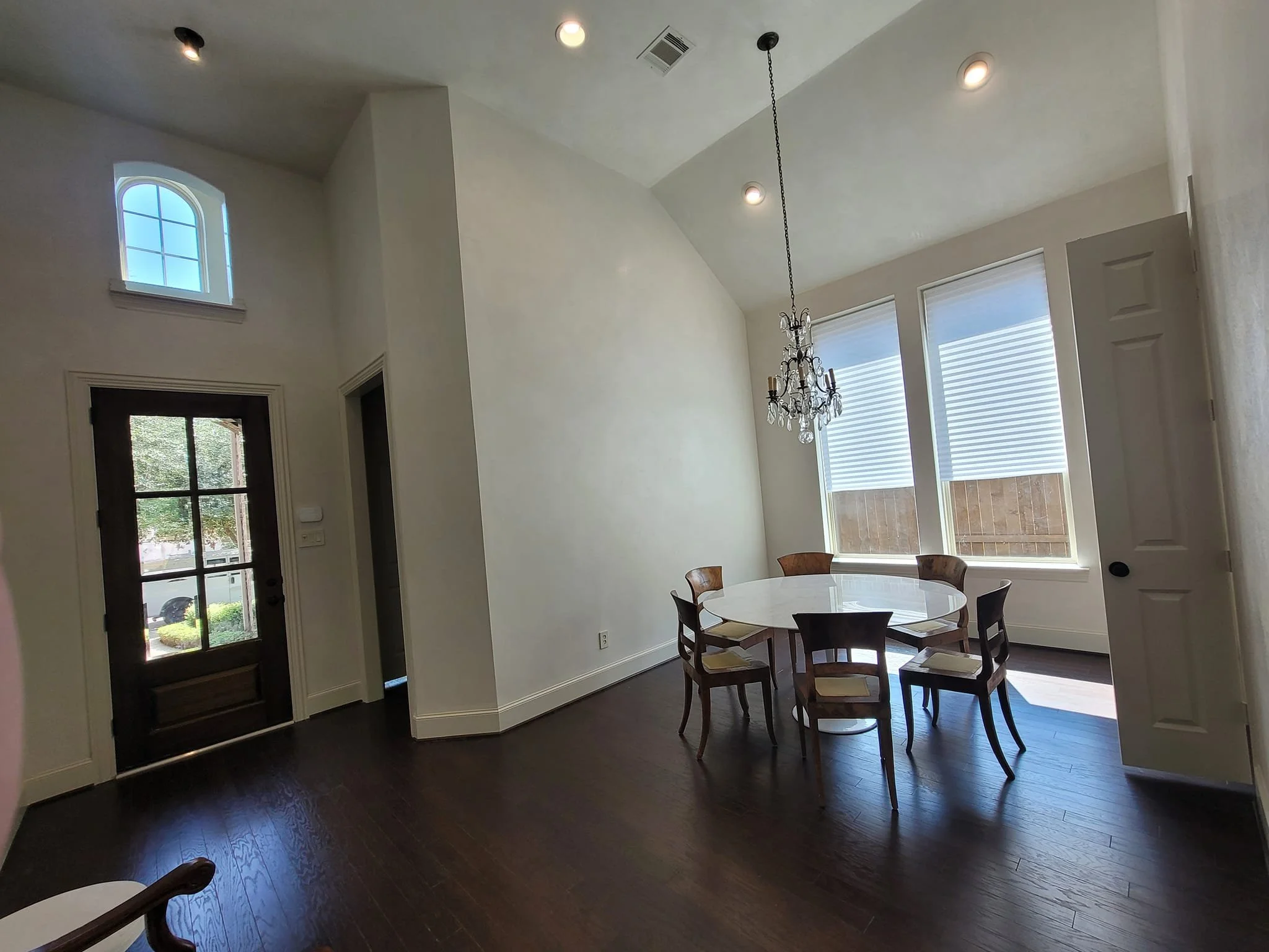 Color-drenched interior entryway and dining room in off-white in Missouri City, Texas