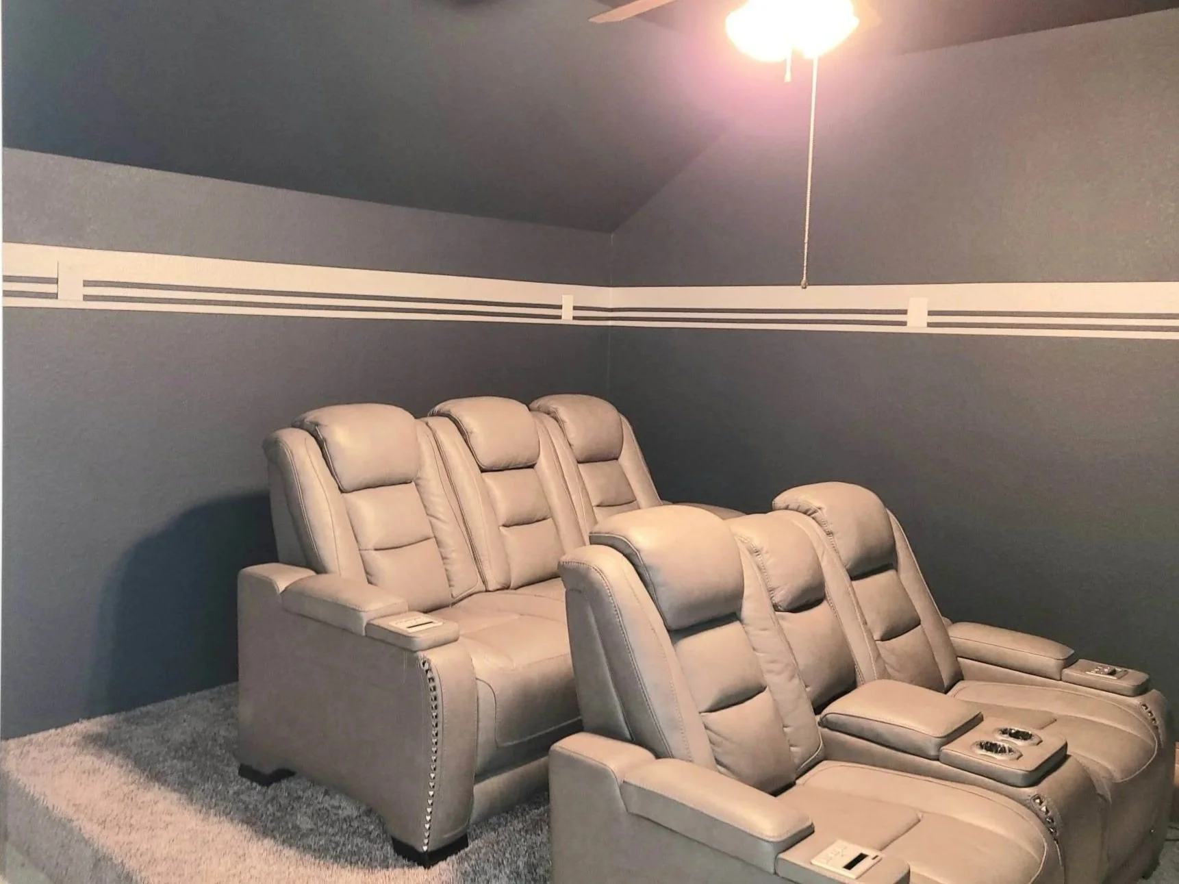 Media room interior repaint featuring dark accent walls, clean trim lines, and controlled finishes designed for low-light environments.