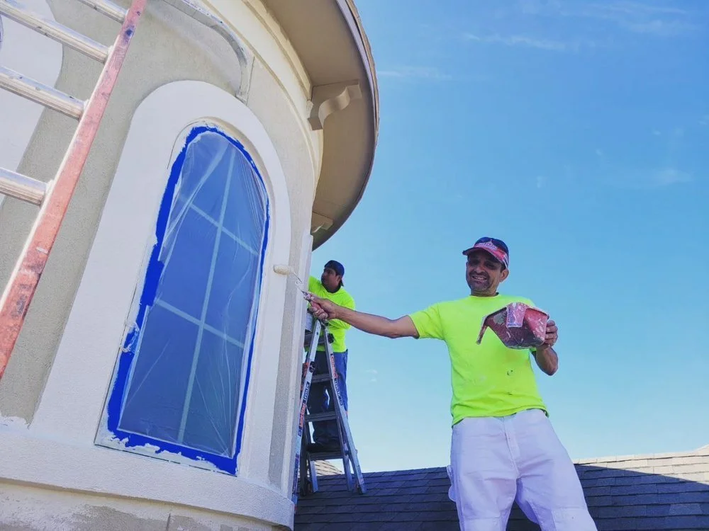 Two painters working on stucco exterior in Richmond, Texas