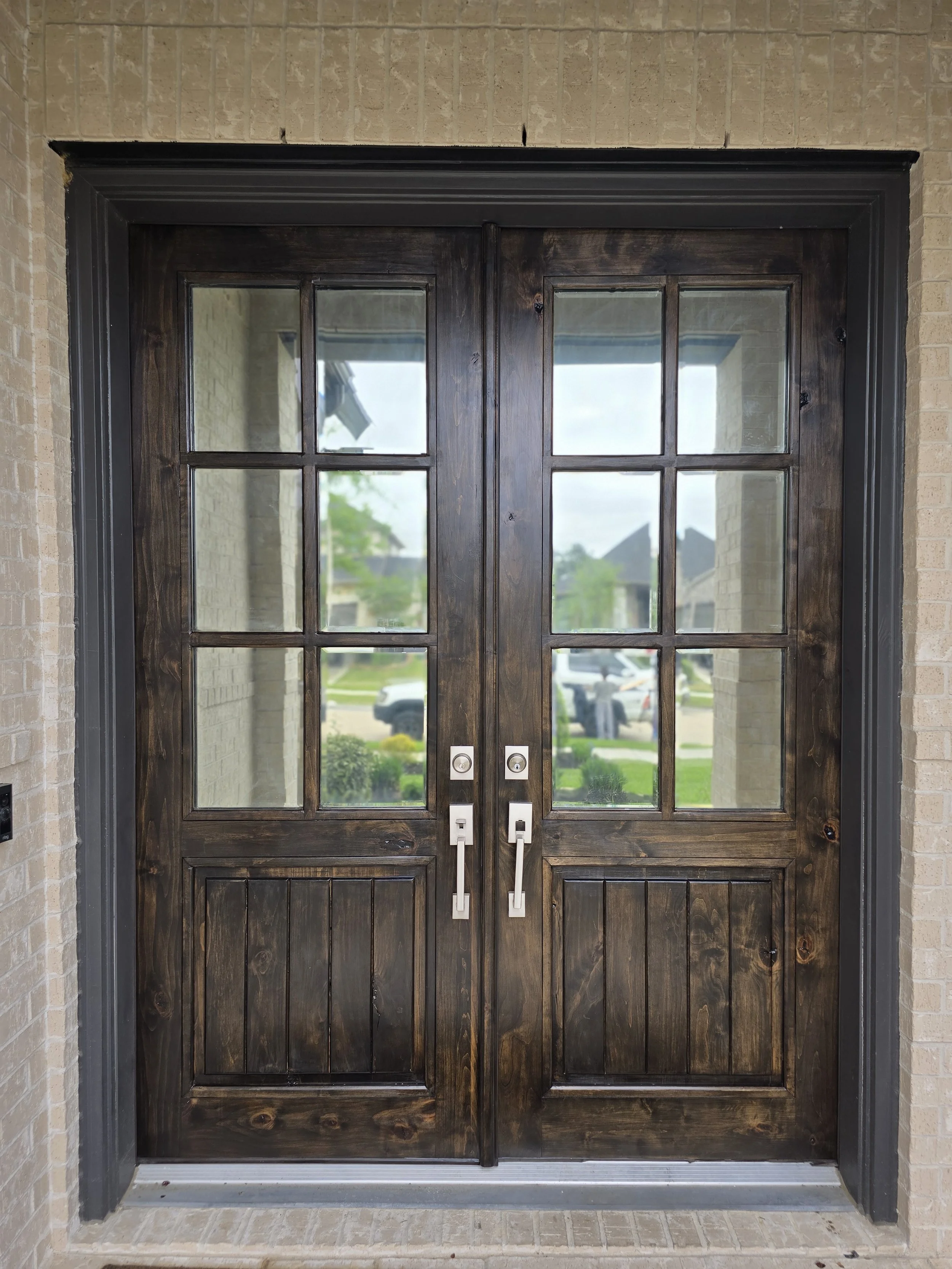 Double front door refinished in dark walnut color in Katy, Texas with rich stain and smooth professional finish by The Proud Paintbrush