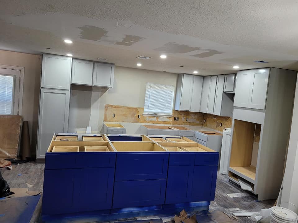 Freshly painted kitchen with navy blue island and gray cabinets in Southwest Houston, Texas