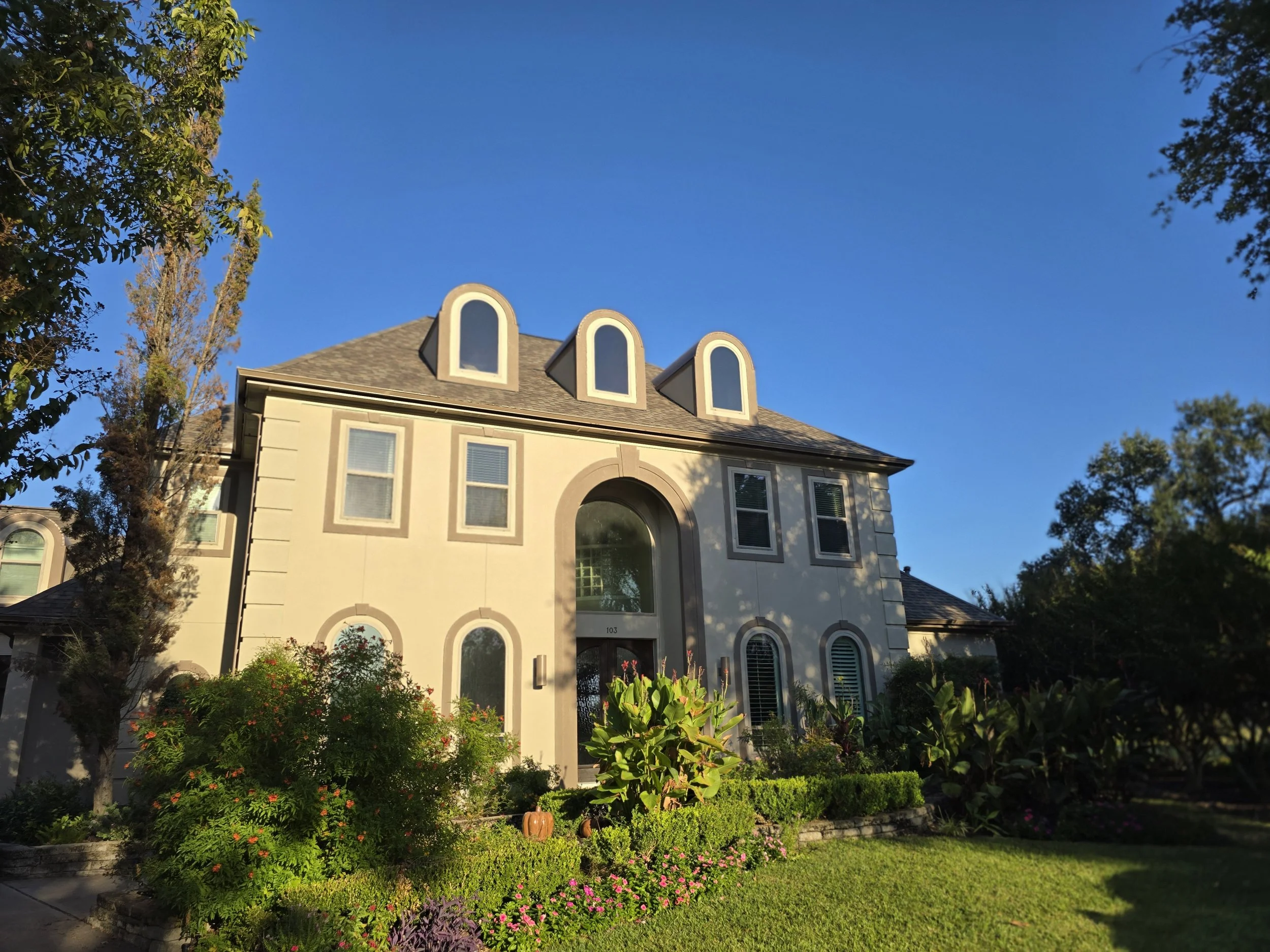 Freshly painted home exterior in West Houston with clean trim lines and updated neutral color scheme