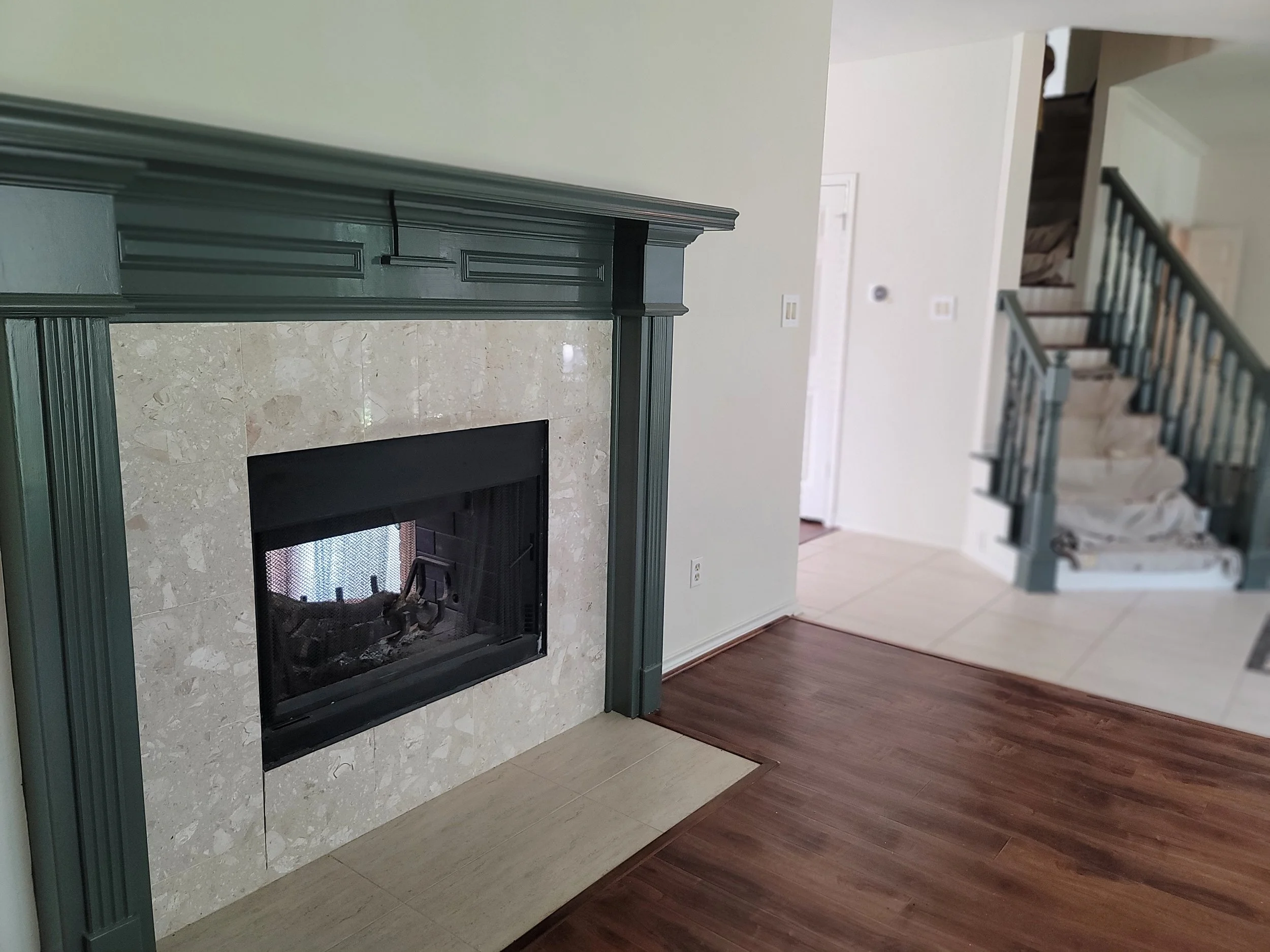 Freshly painted fireplace mantel with a clean modern finish in a Sugar Land home