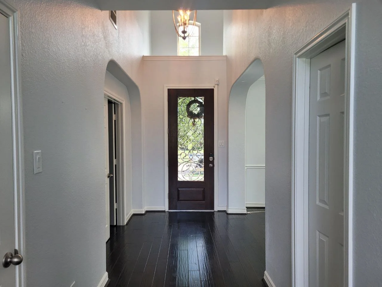 Freshly painted two-story hallway in a cool off-white in Richmond, Texas.