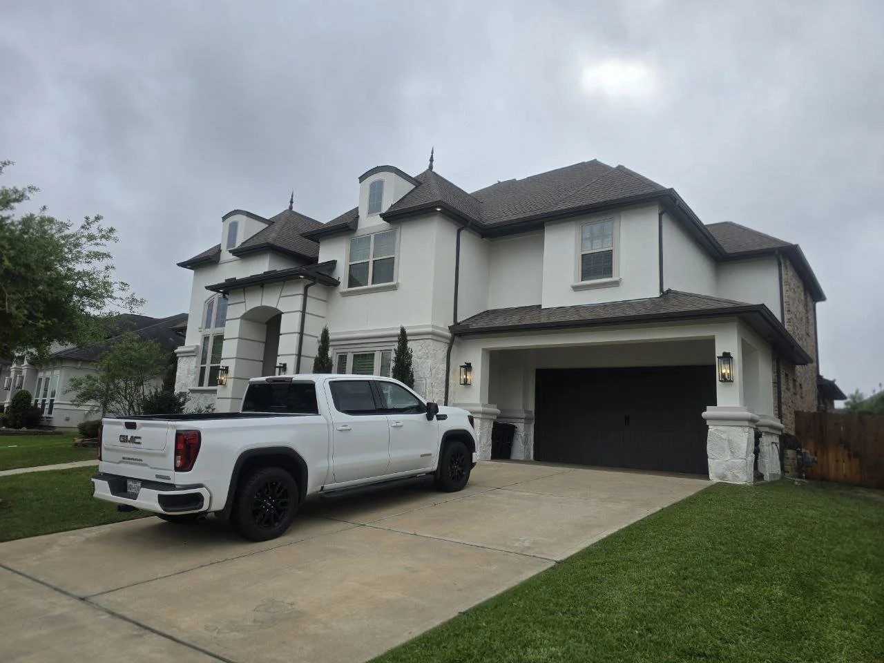 Freshly painted stucco and stone exterior with limewash finish in Fulshear, Texas