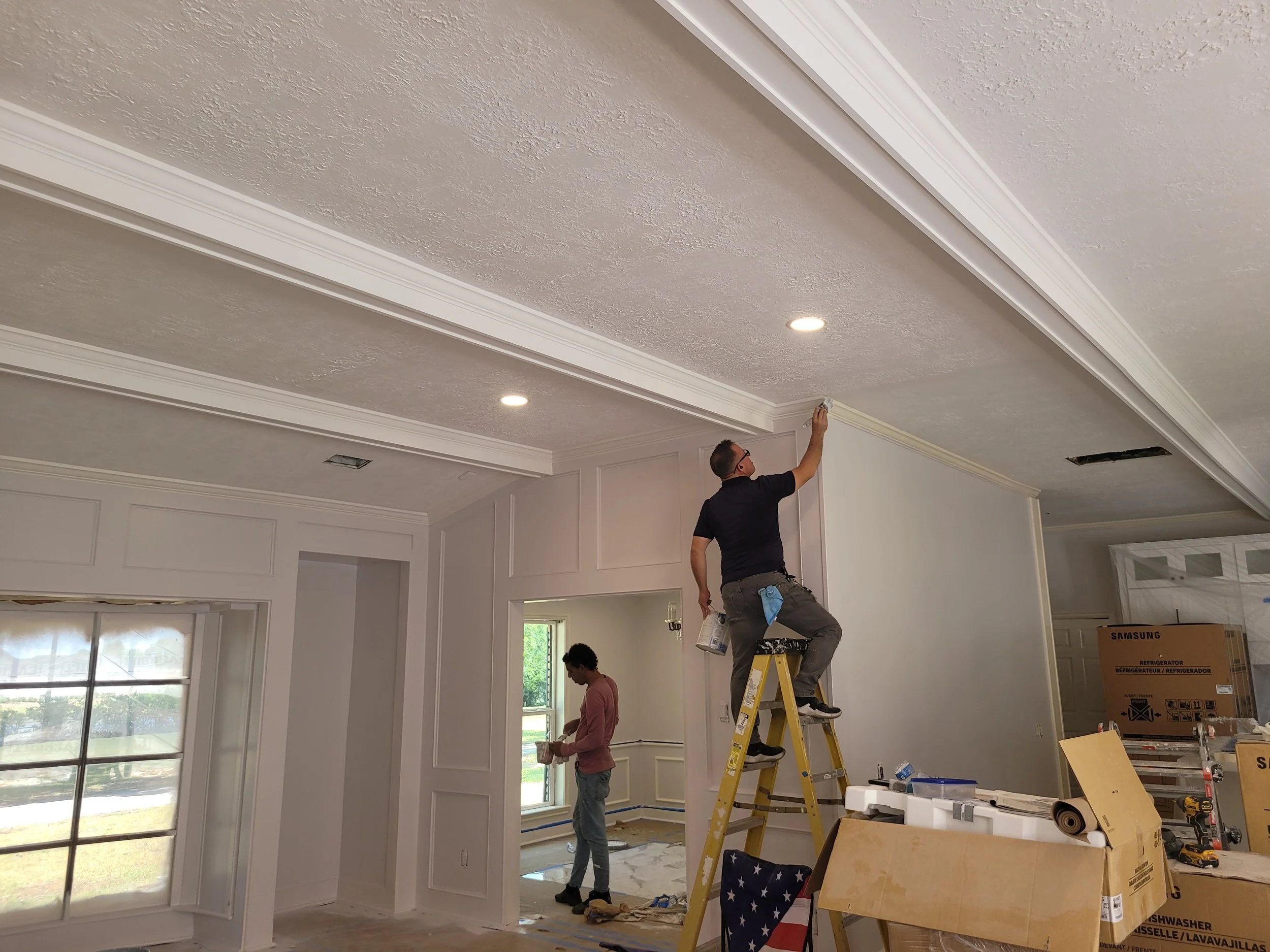 Professional interior painting in progress inside a Southwest Houston home