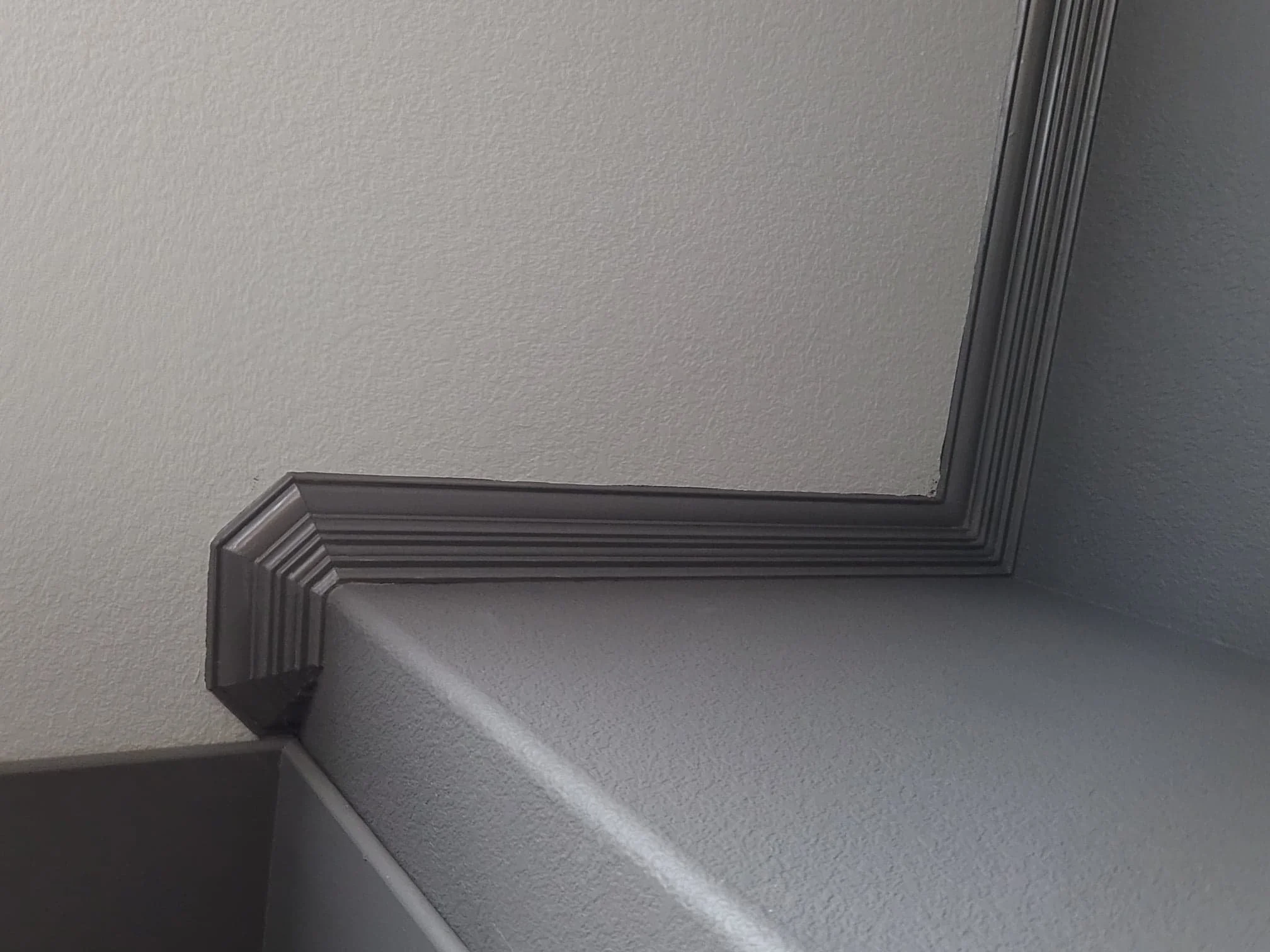 Freshly painted crown molding with a clean, smooth finish in a Southwest Houston home
