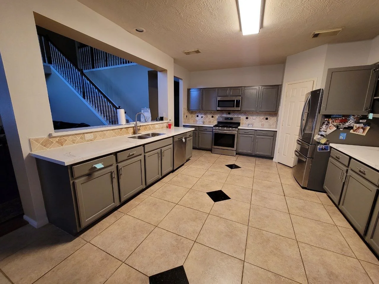 Freshly painted dark gray kitchen cabinets with spray finish in Richmond, Texas