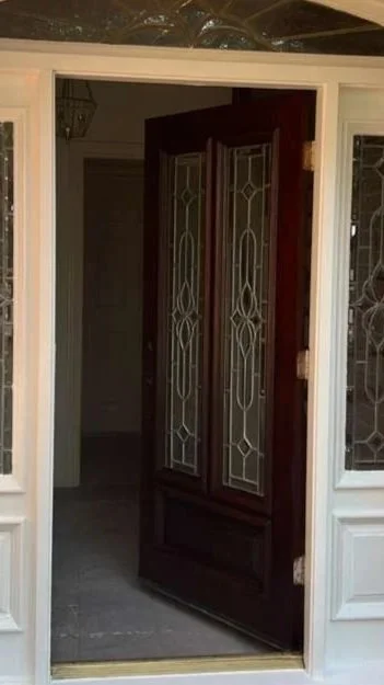 Freshly stained front door in red chestnut color in Richmond, Texas.