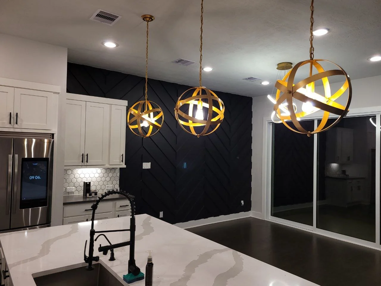 Freshly painted kitchen interior with a black accent wall in Katy, Texas.