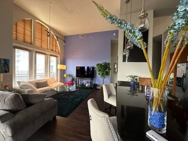 Living room with a periwinkle accent wall and freshly painted interior in West Houston