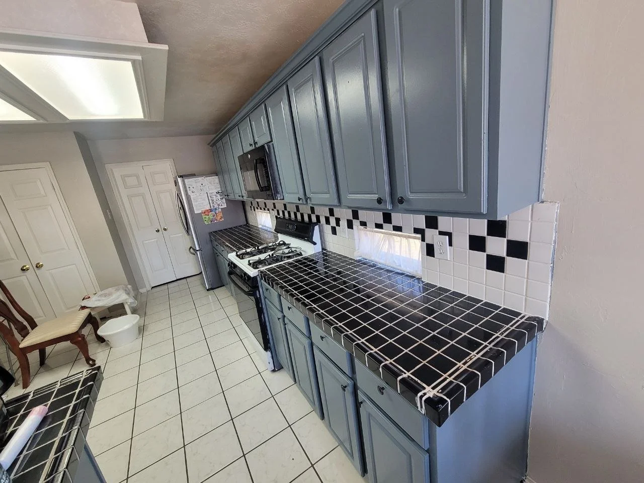 Freshly painted gray-blue kitchen cabinets in Richmond, Texas