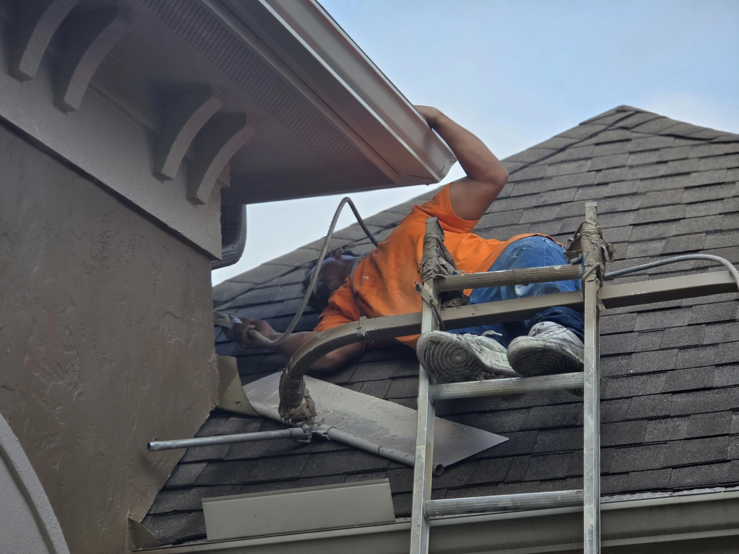 “Exterior painting detail work along the roofline of a home in Richmond, Texas”