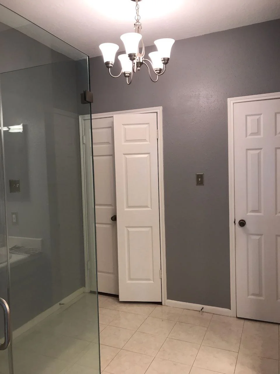 Freshly painted dark blue-gray bathroom walls with a smooth finish in Missouri City, Texas
