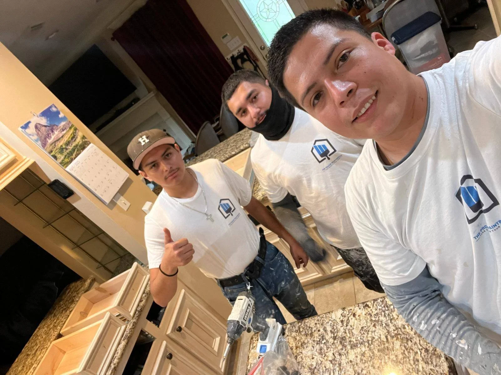 The Proud Paintbrush painting team posing during a residential painting project in Sugar Land, TX.