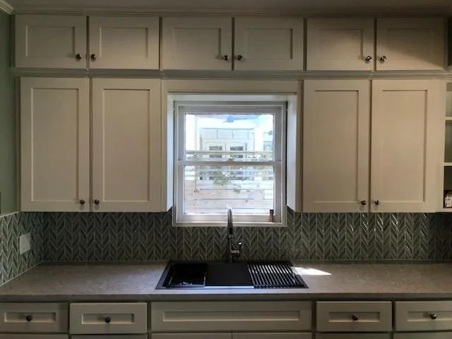 Freshly painted kitchen cabinets with a clean modern finish in a Fulshear, Texas home