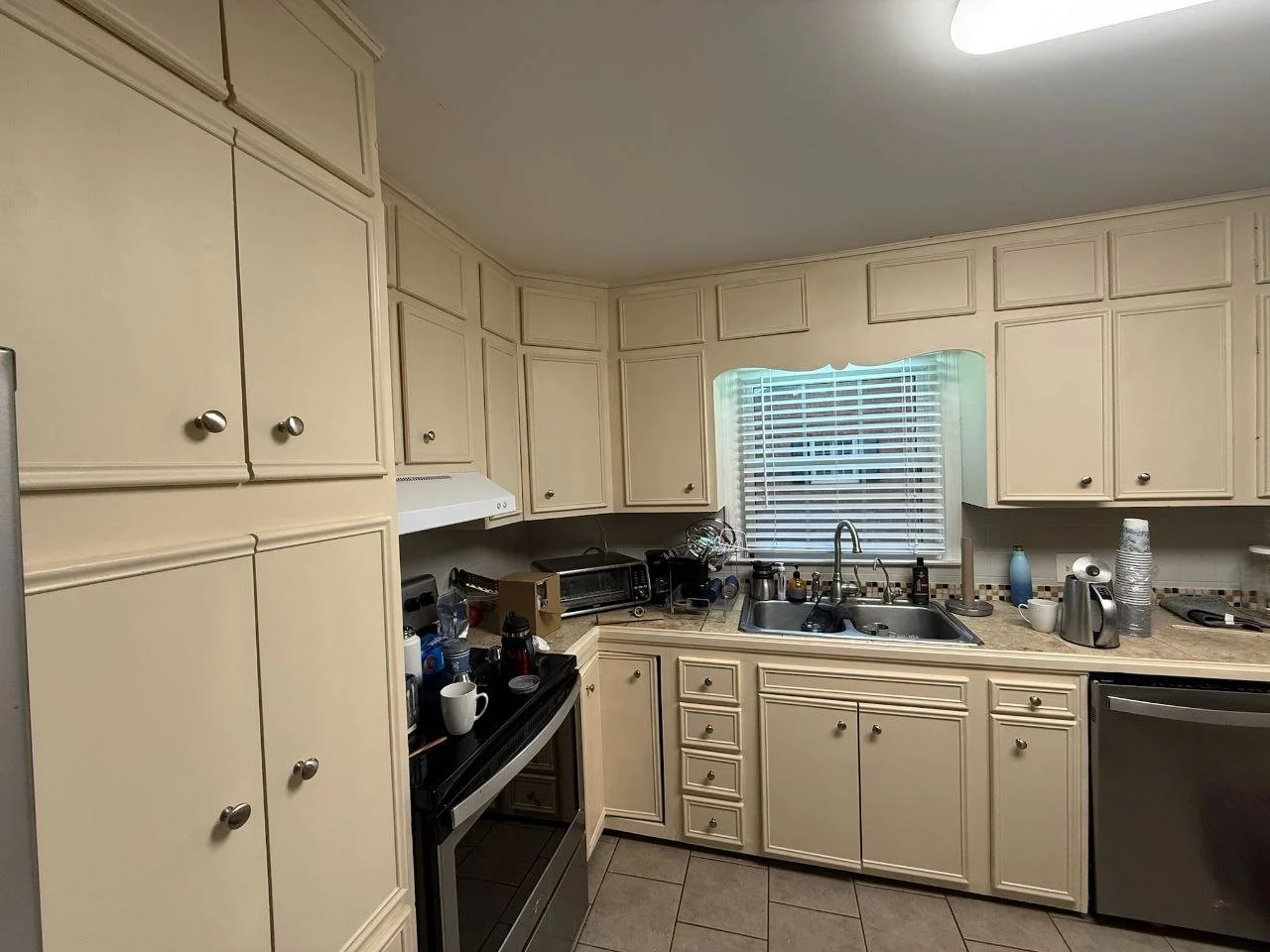 Freshly painted warm off-white kitchen cabinets in Rosenberg, Texas