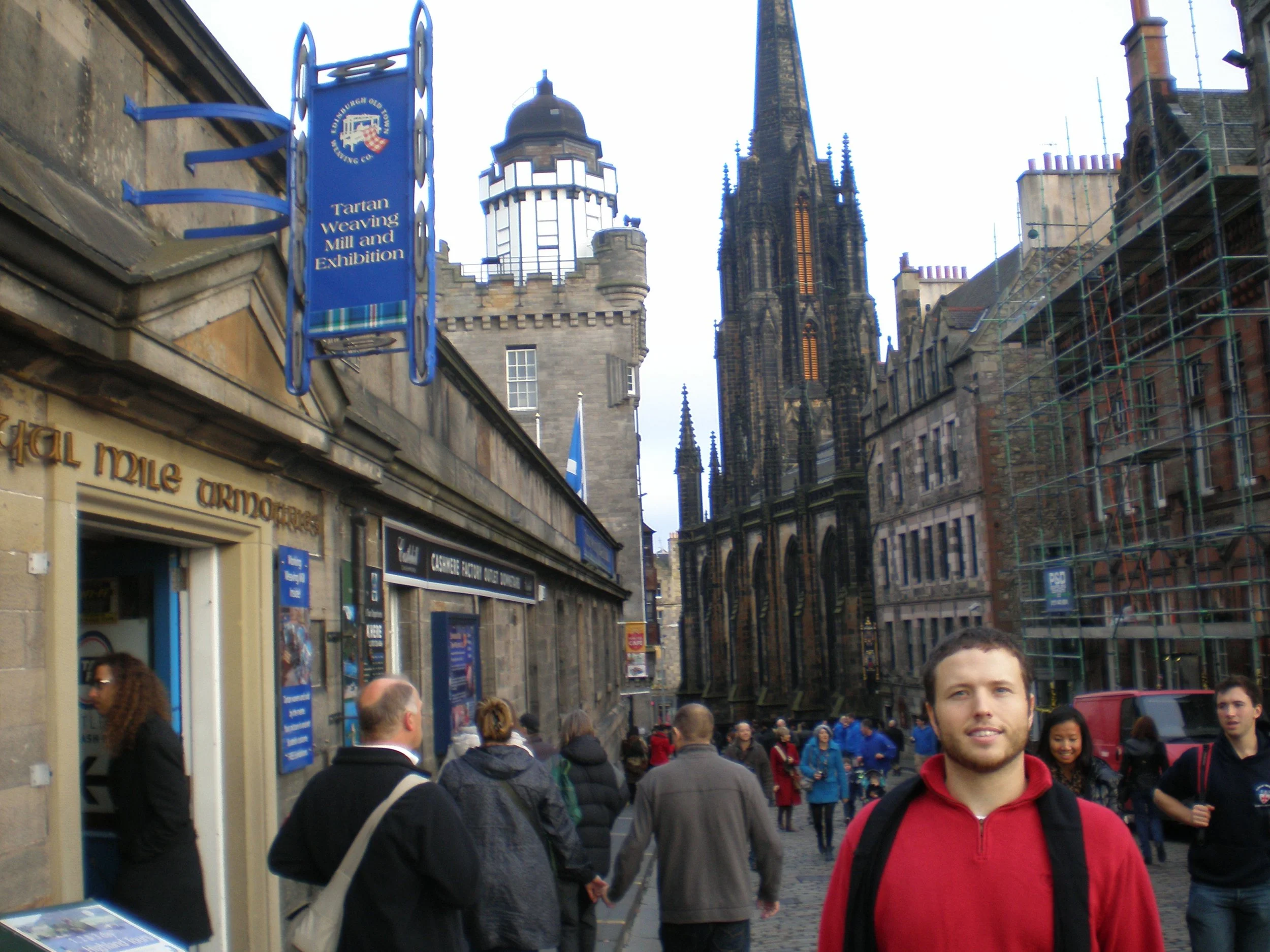The author's husband in a red sweater standing on the Royal Mile in Edinburgh