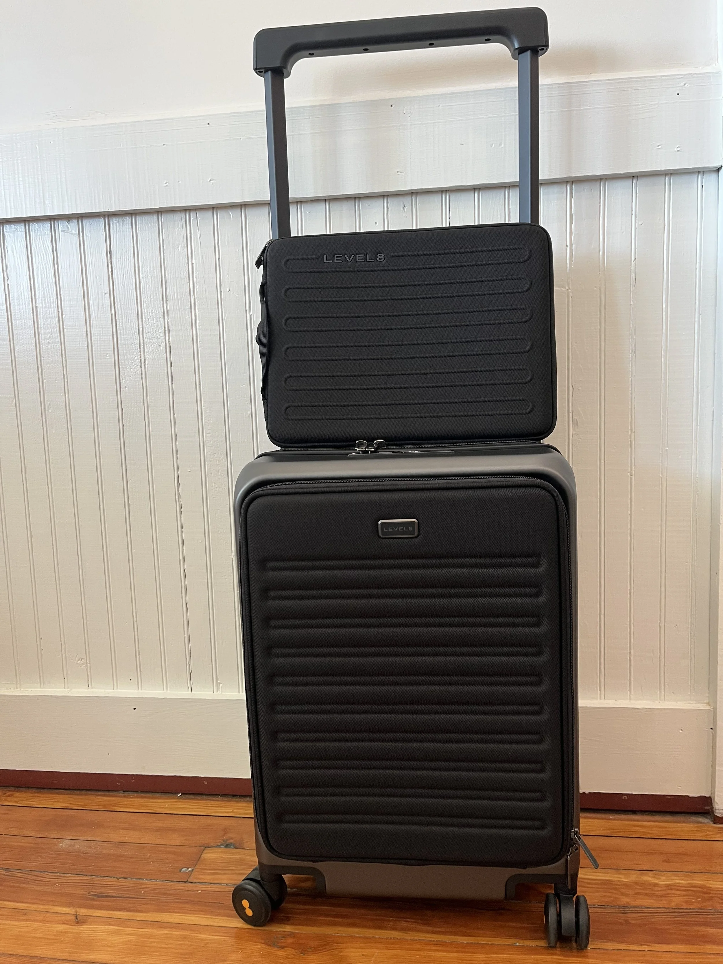 The laptop case in comparison to the suitcase