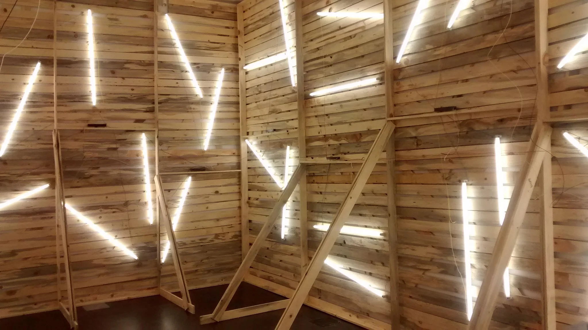 Art installation with wooden walls and tube lighting at the Museum of Contemporary Art in Denver, Colorado