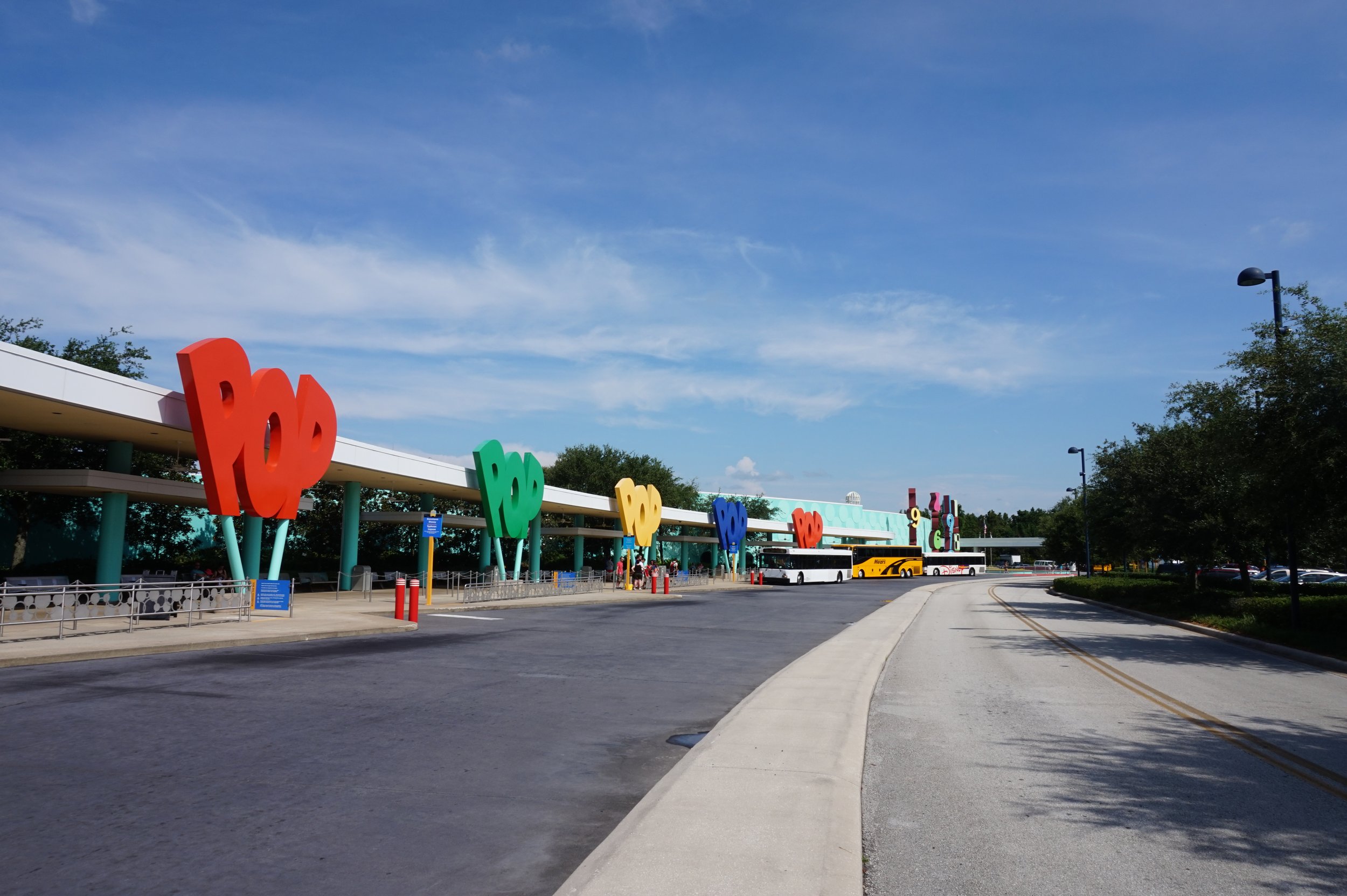 Resort buses park for passengers in front of Pop Century Resort