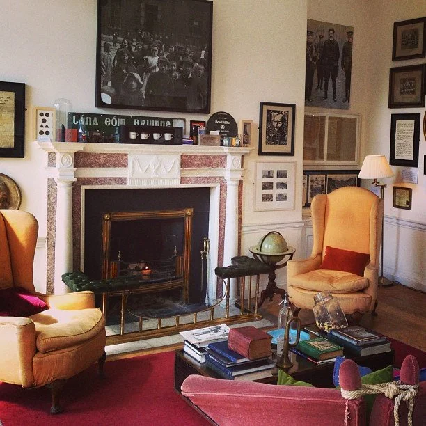 Yellow armchair sit beside a fireplace in the Little Museum in Dublin