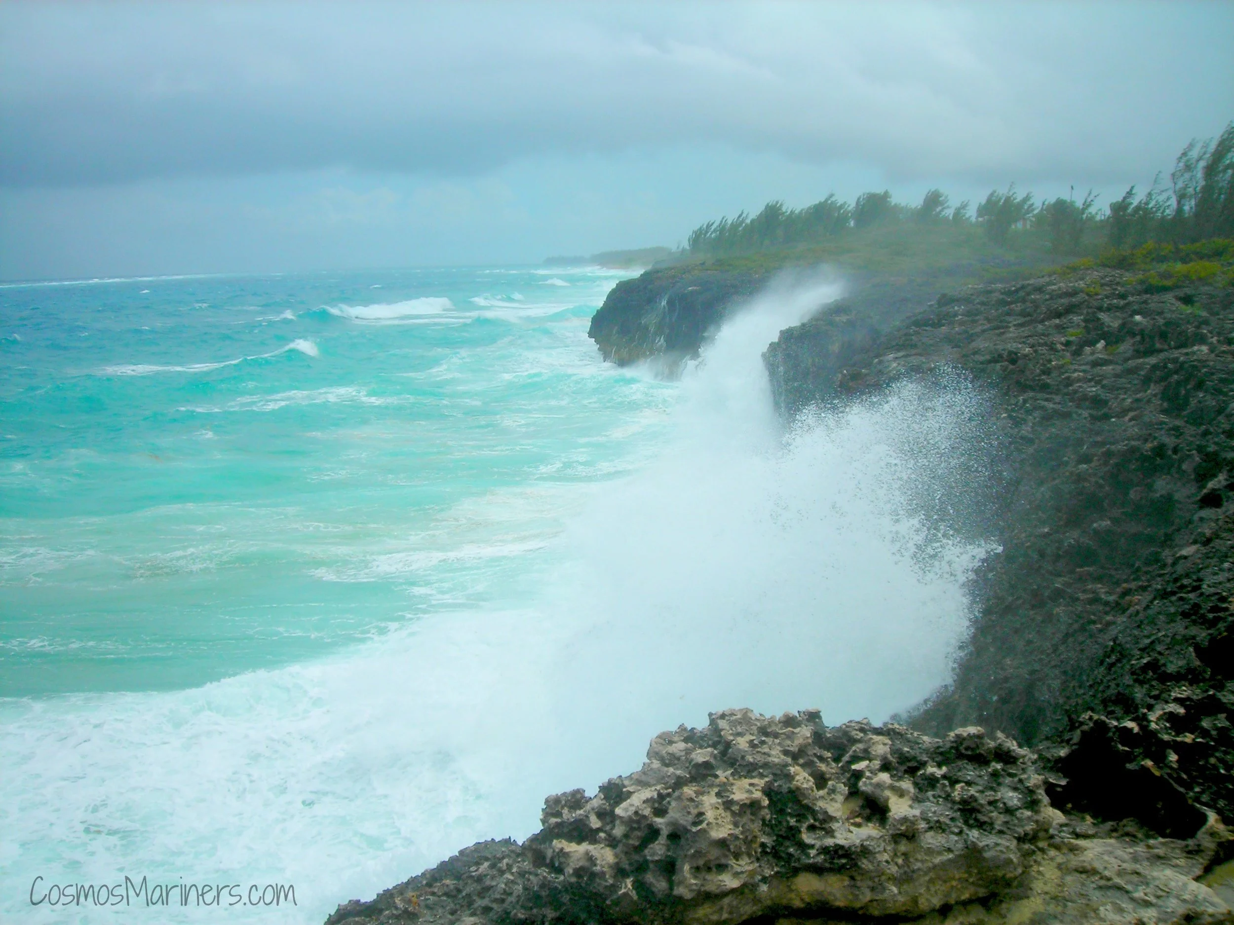 The crashing surf up onto Morgan's Bluff with blue waters beyond