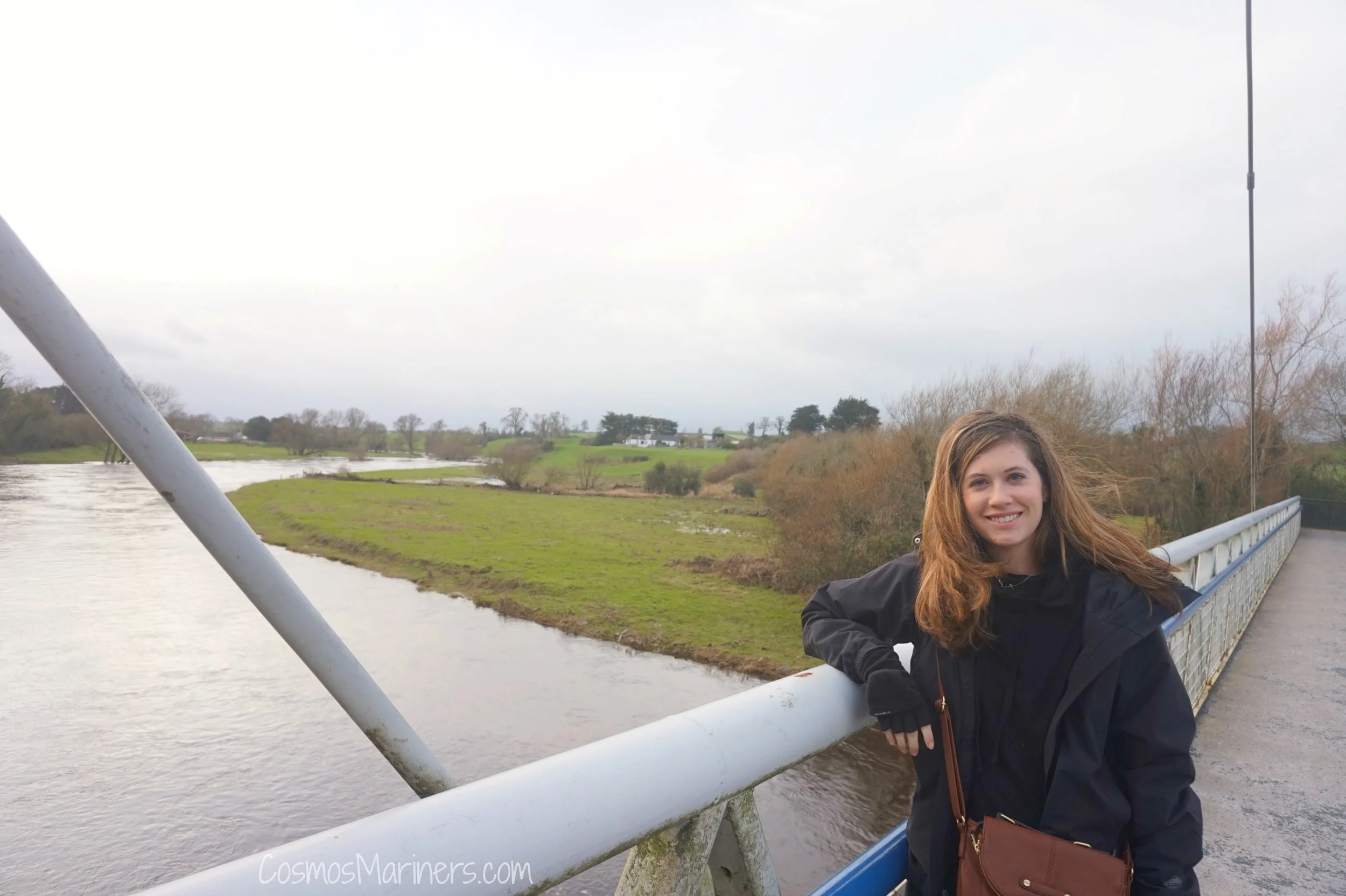 The author on the metal footbridge between the visitors center and tour bus pick up area at Newgrange