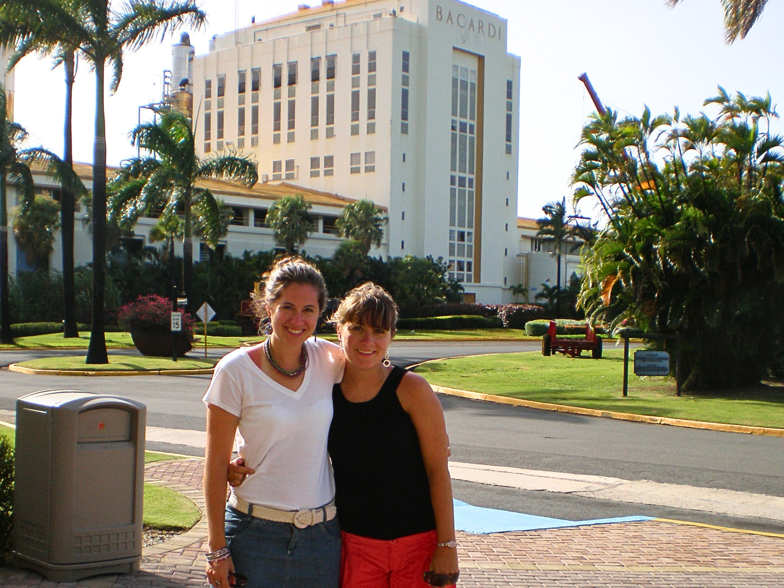 The author and her sister standing outside of the main building at the Bacardi Factory in Puerto Rico
