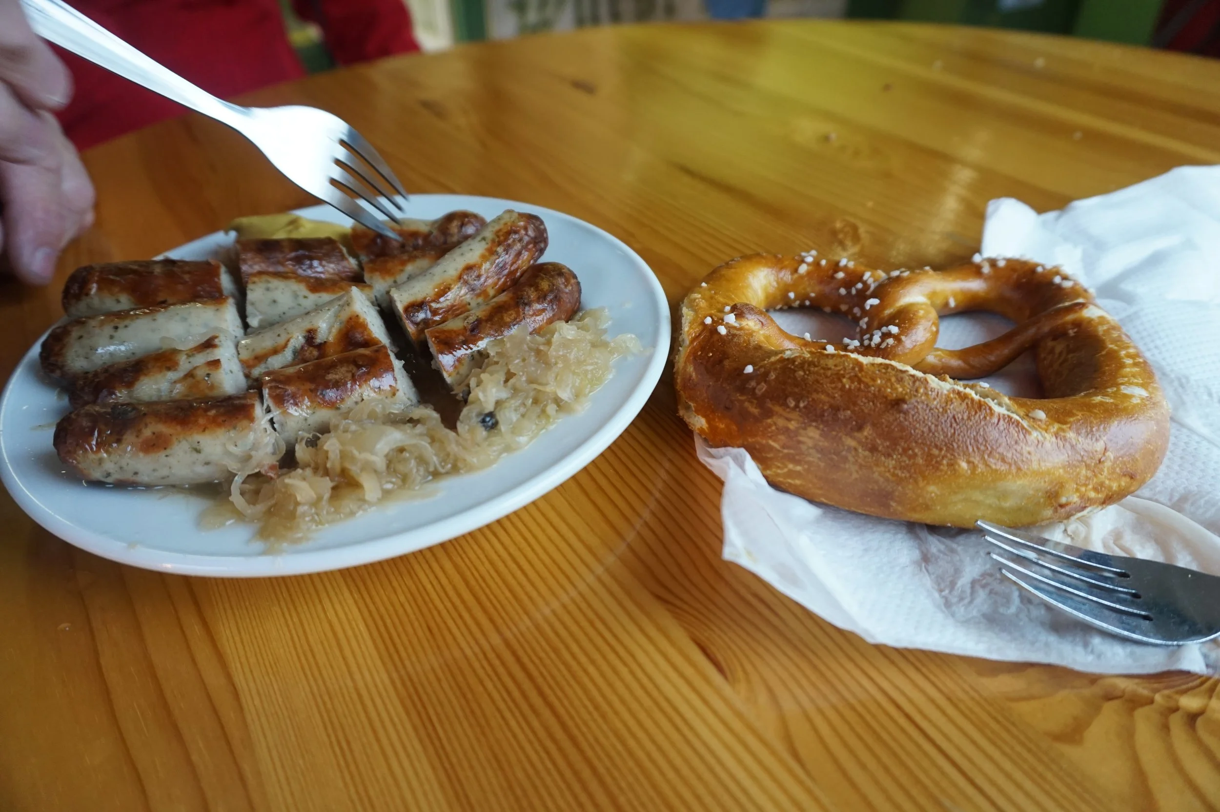 Large pretzel with sausage, mustard, and sauerkraut