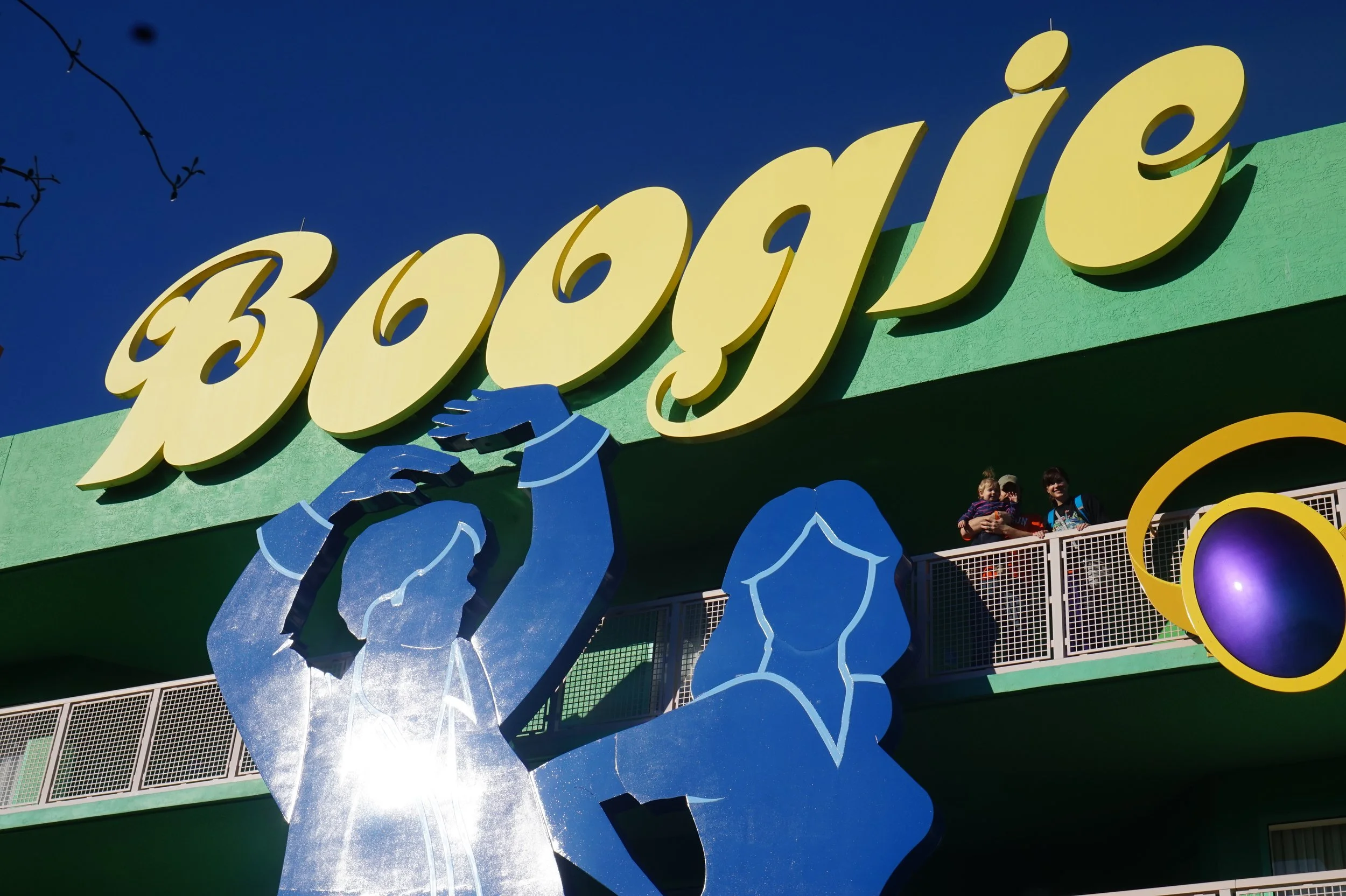 The author's family standing under a sign that says Boogie in the Pop Century resort