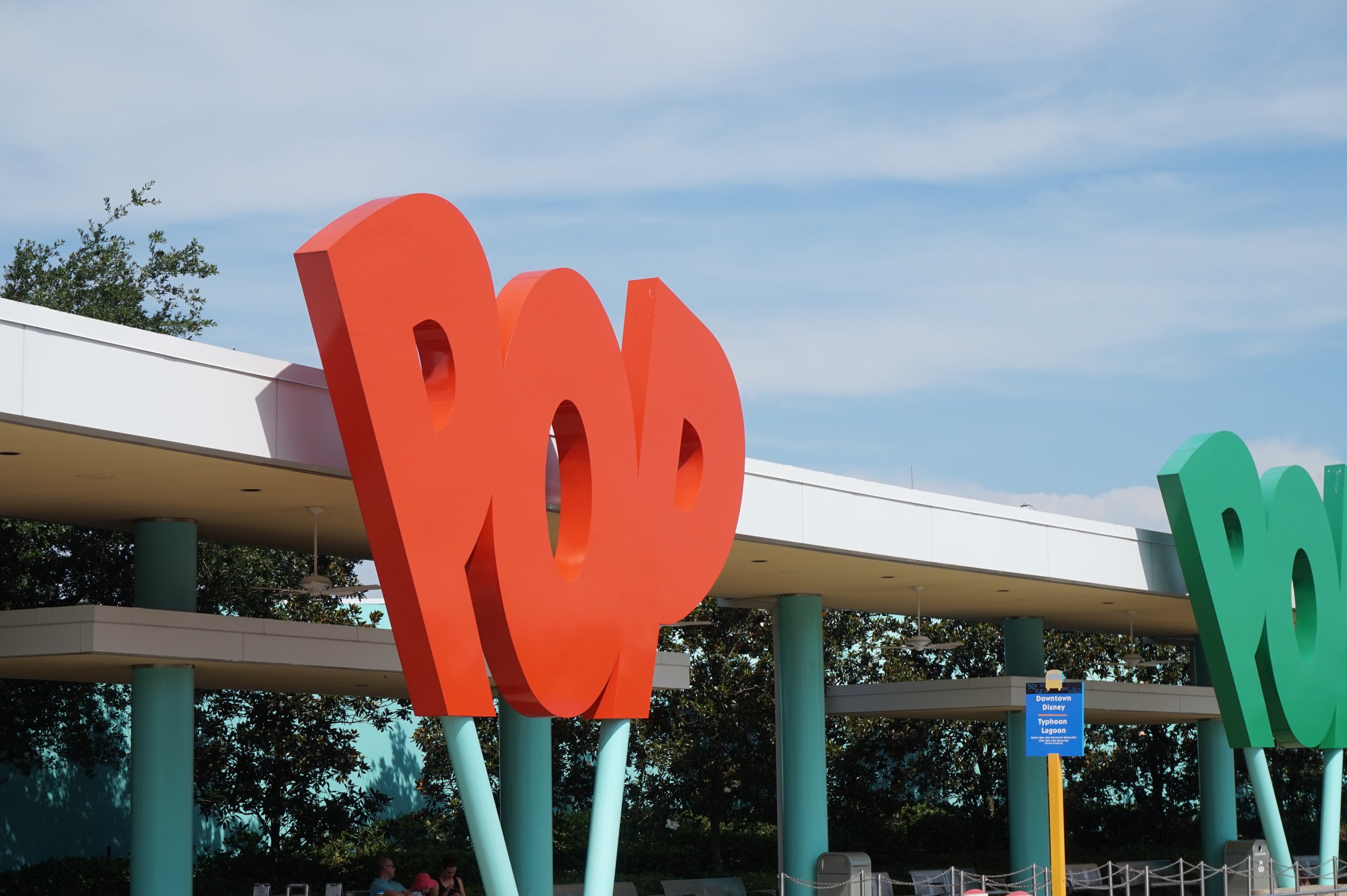Bright red, large sign on exterior of Pop Century building that says "POP"