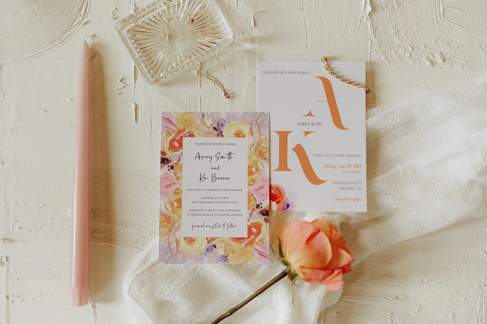 Two invite options set up with candle and flower