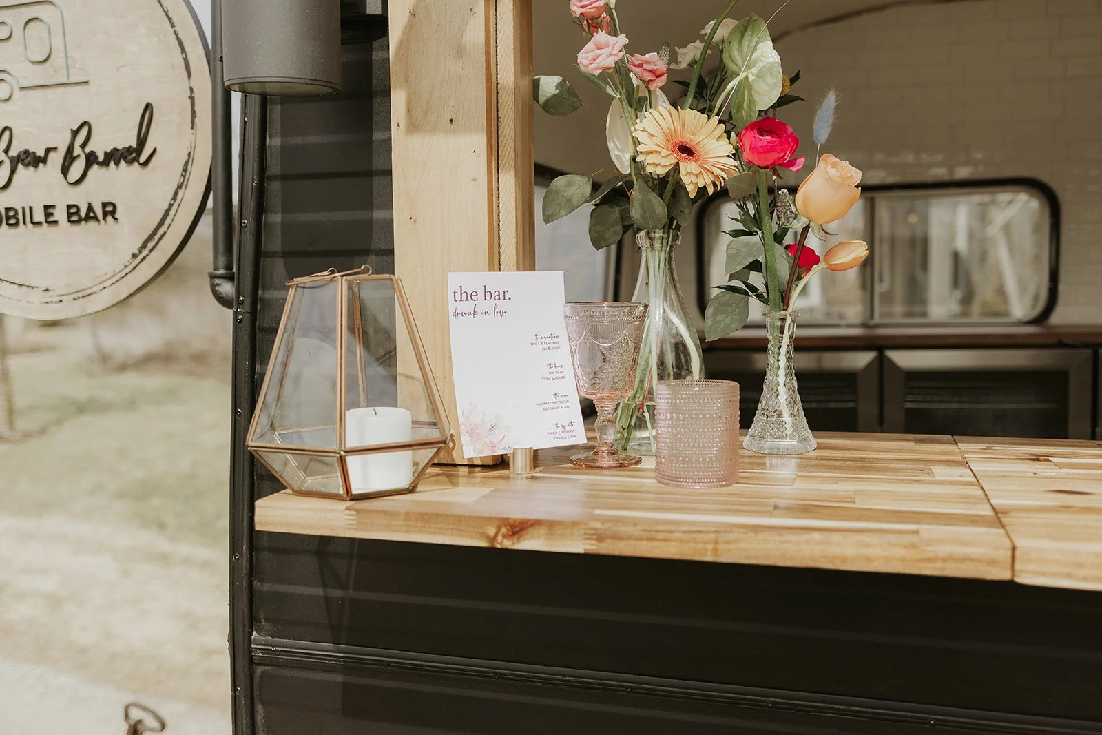 Bar menu on bar with flowers, cups and candle