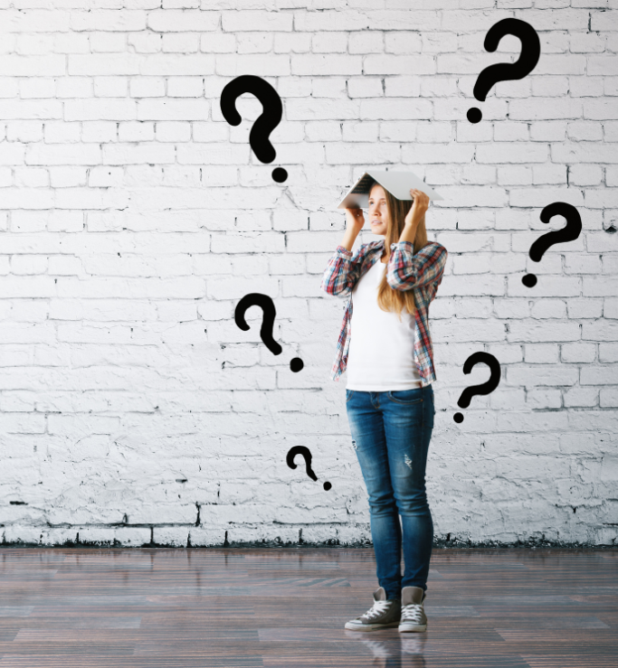 Confused woman standing in front of question marks, representing self-doubt, overthinking, and self-sabotaging thoughts.