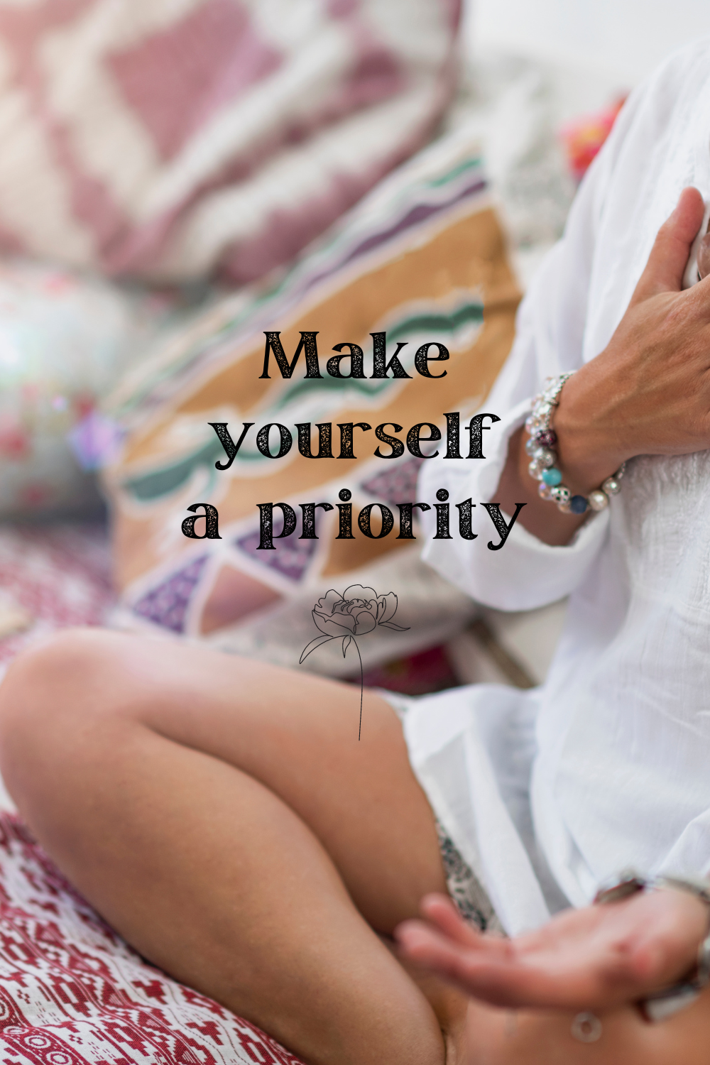 Woman sitting comfortably on a bed with the message “Make yourself a priority,” encouraging self-care and intentional use of time and energy.