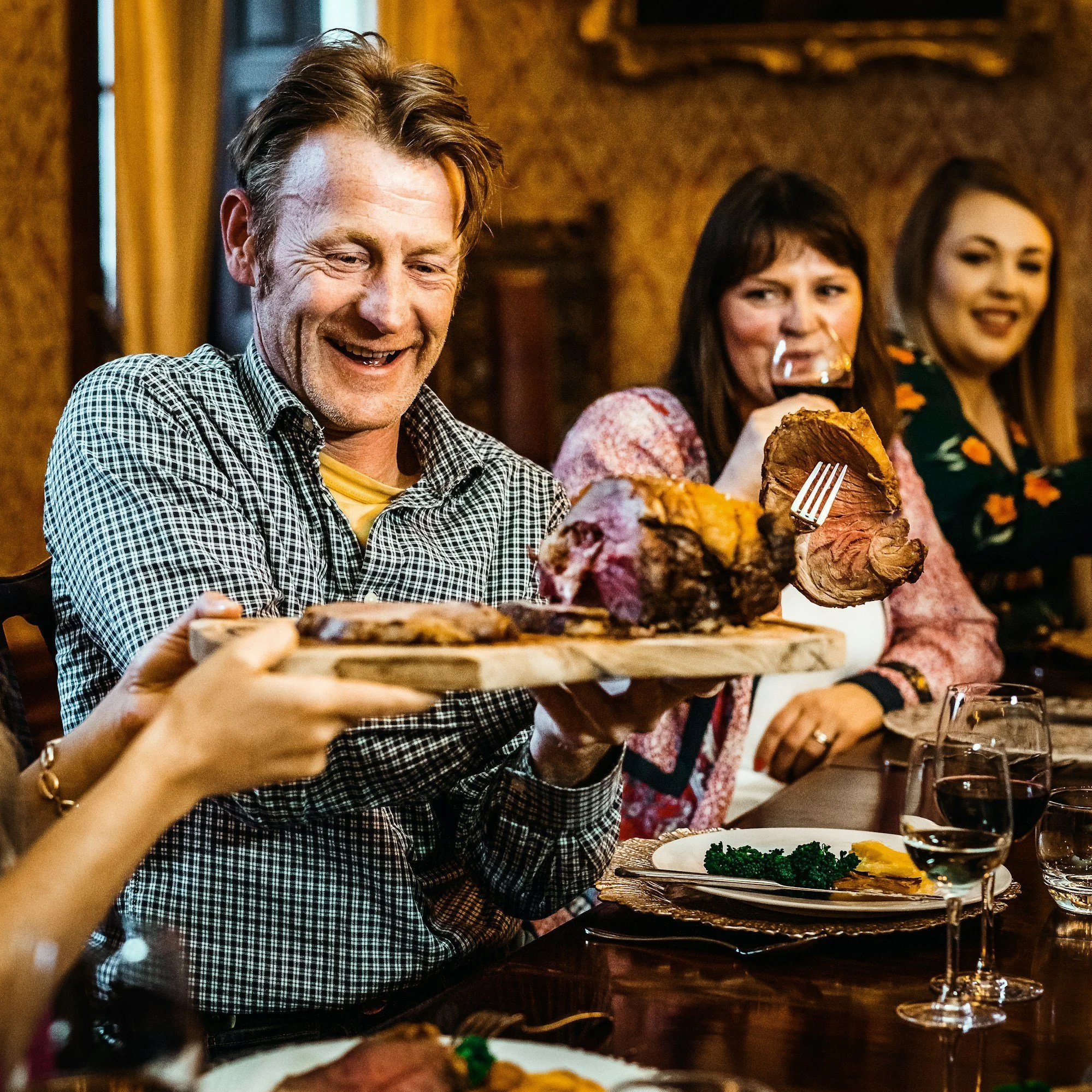 Family sharing a Christmas meal together, representing meaningful connections and spending time with supportive loved ones.