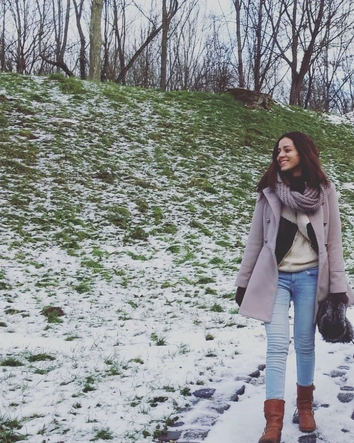 Woman walking outdoors in nature, promoting mindfulness, stress relief, and mental wellbeing.