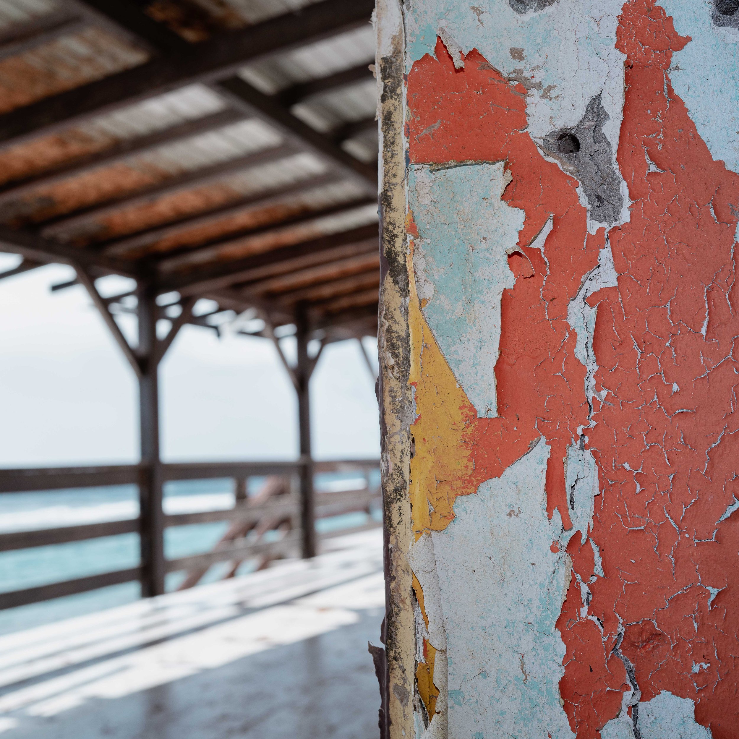 Photographie prise à la Désirade, révélant l'envers du décor paradisiaque entre stigmates du passé et présence humaine discrète. Photographie issue de la série "InDésirade" de Sophie Tournois, développée dans le cadre du mentorat photo en ligne de Pr