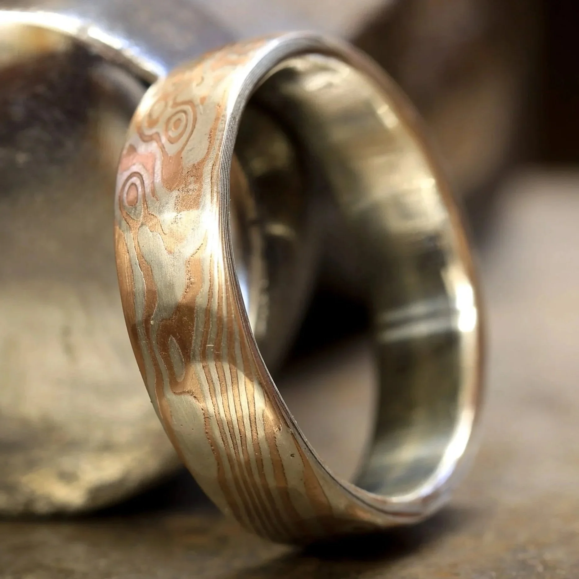Close-up of a metal bearing inside a mechanical component, with visible concentric rings and a textured, patterned surface on the outer ring.