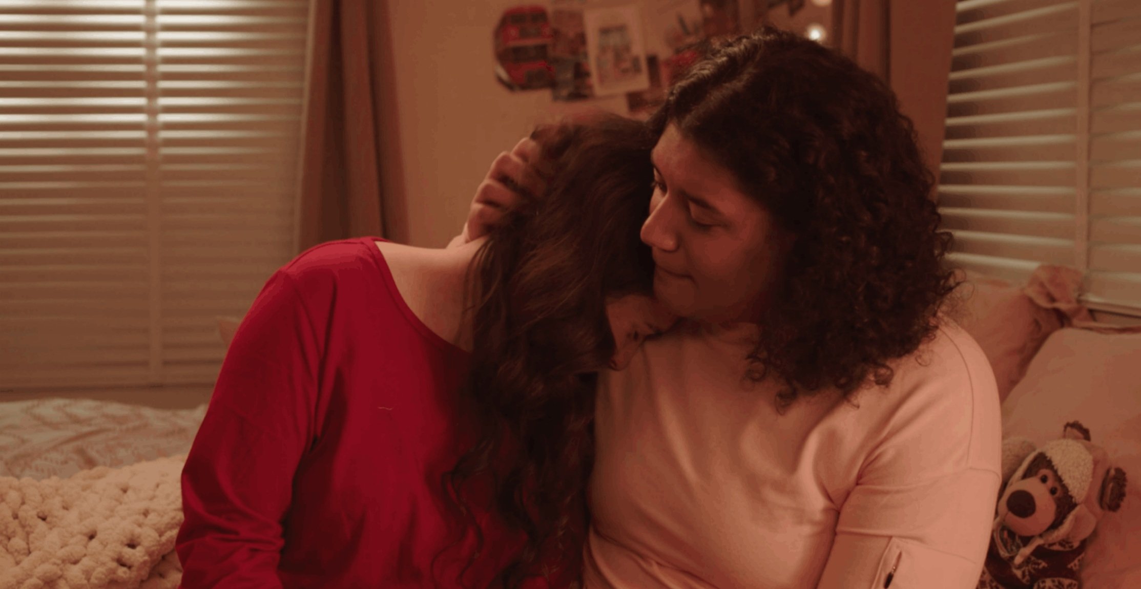 Young woman resting her head on another woman's shoulders