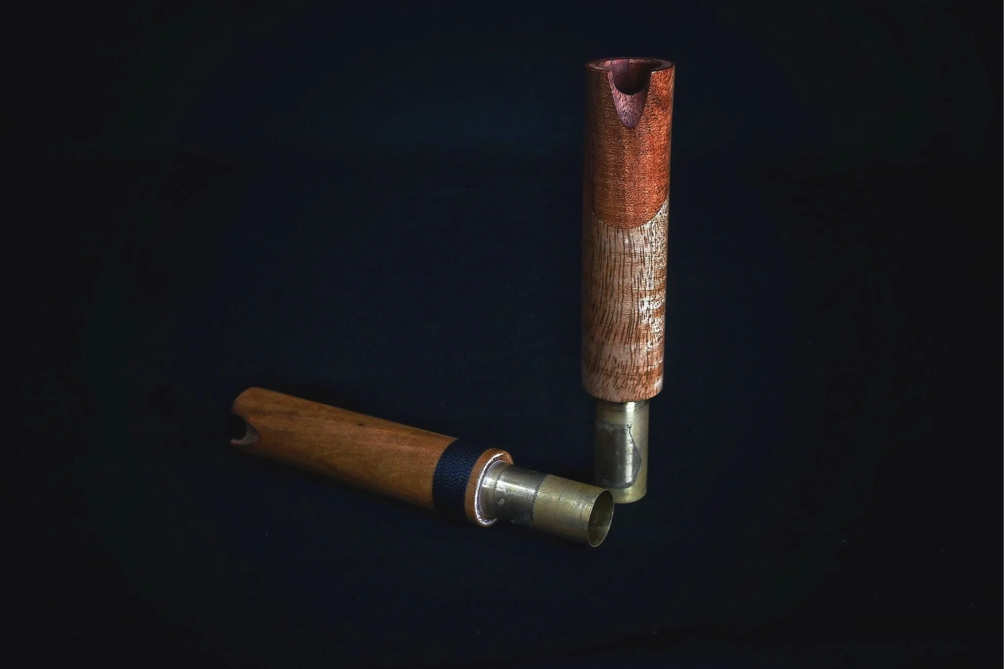 Two wooden head joints arranged in an L-shape on a black background.