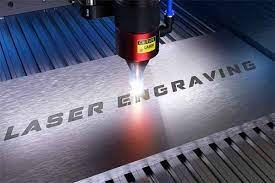 A laser engraving machine etching text on a metal surface