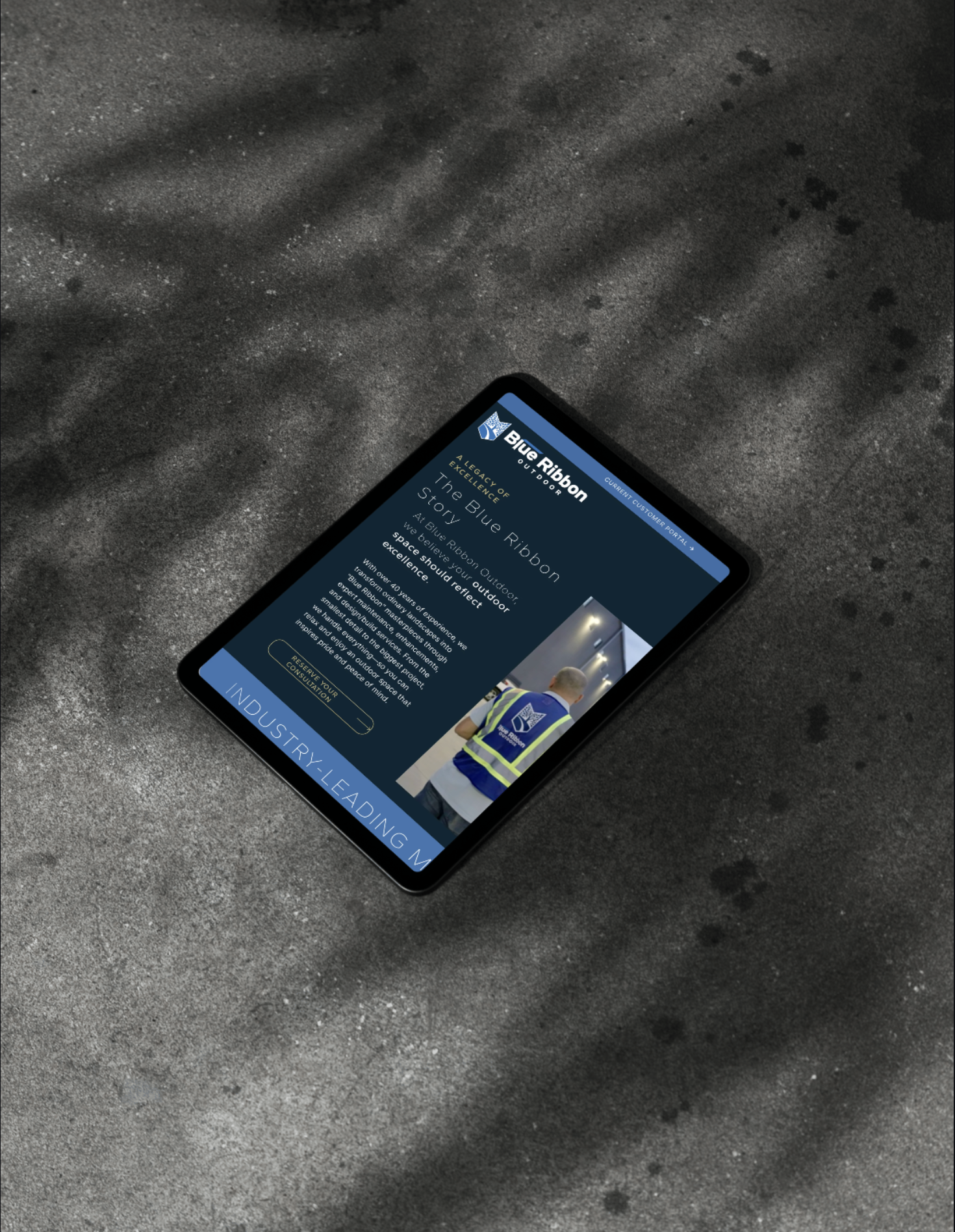 iPad on concrete with Blue Ribbon Outdoor about page
