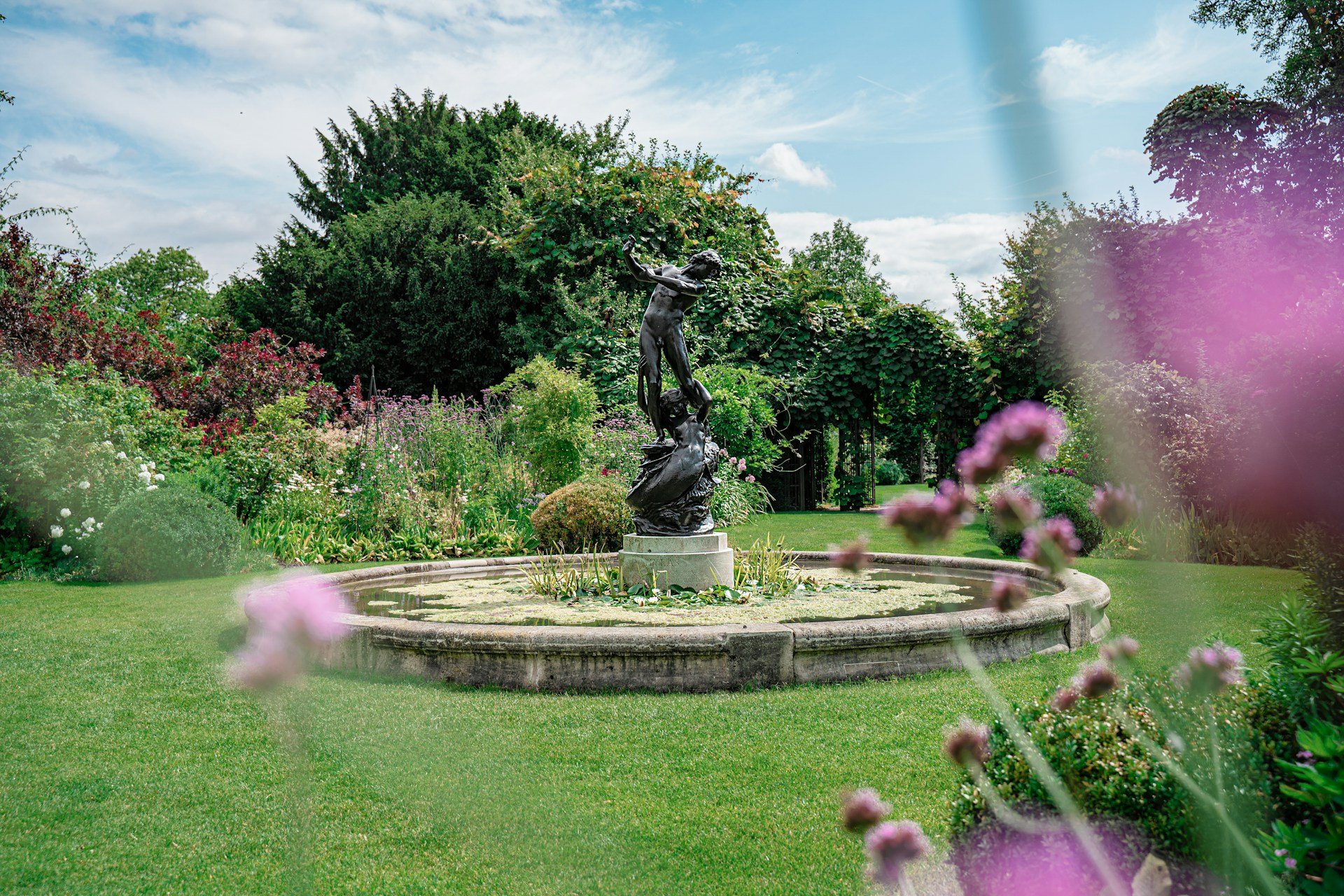 Garden with fountain and old statue